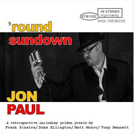 50s style jazz album cover has yellow and red text reading round sundown with background photo of jon paul rat pack singer.